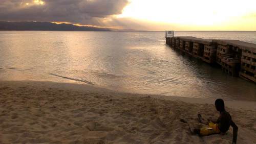 Boy on the beach at sunset. Montego Bay, Jamaica, December 2013.